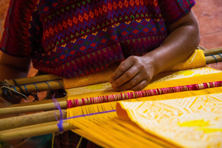Guatemalan artisan weaving using a traditional backstrap loom