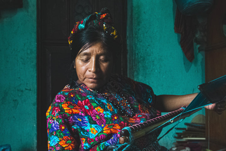 Artisan from Guatemala weaving using traditional backstrap loom method
