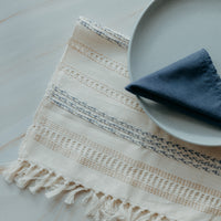 Beige and light blue placemat and blue napkin
