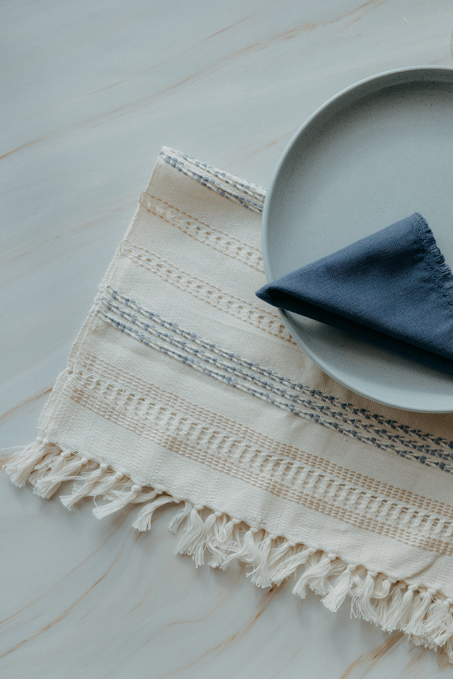Beige and light blue placemat and blue napkin
