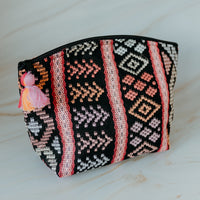 Colorful handmade travel pouch bag with attached tassel detail