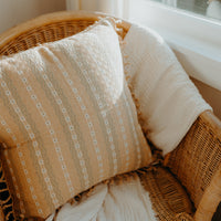 Handmade beige cushion cover in armchair