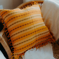 Yellow cushion cover on armchair 