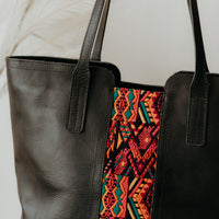 Black leather Tote bag featuring upcycled textile in the front