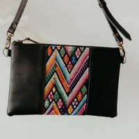 Black leather crossbody handbag, featuring an upcycled colourful textile panel